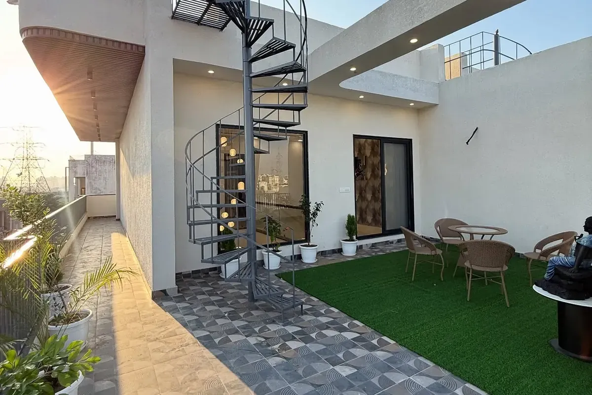 Terrace of a villa built by Foxrun in Noida, with a spiral staircase and finished courtyard